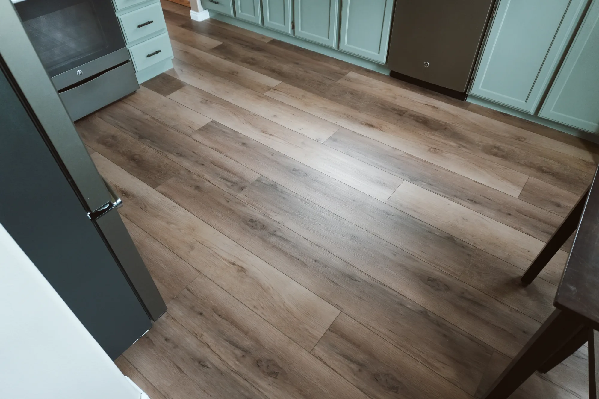 Wide-plank flooring installed in a Pocatello kitchen